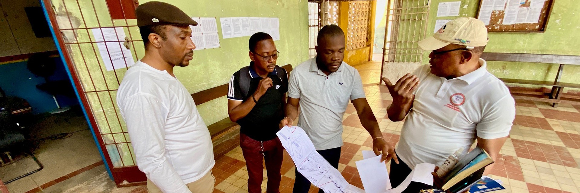 Four people looking at a big paper and discussing